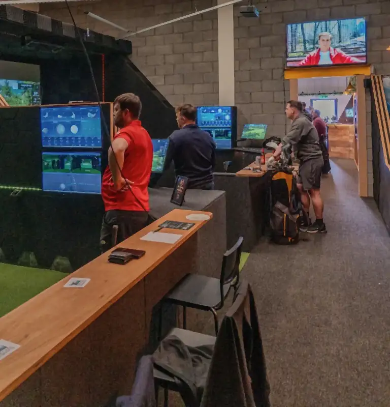 Golfers setting up across the bays on a busy night at Virtual Fairways, Darlington