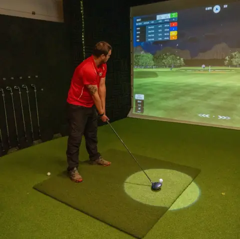 A golfer lining up a shot on the simulator at Virtual Fairways, Darlington